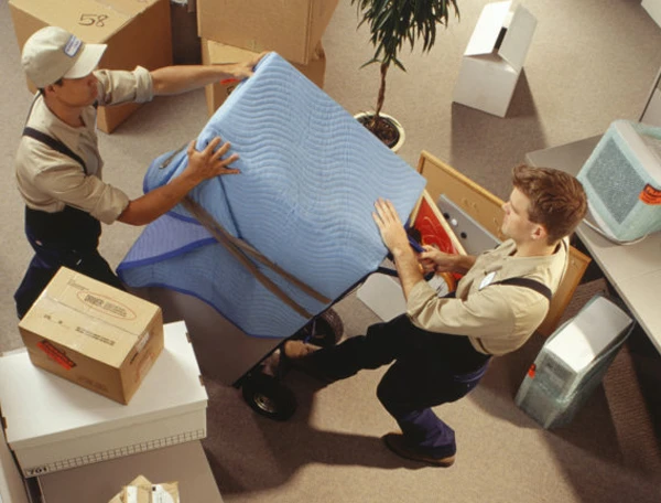 Seattle WA commercial moving team uses a dolly for efficient office furniture and box transport.