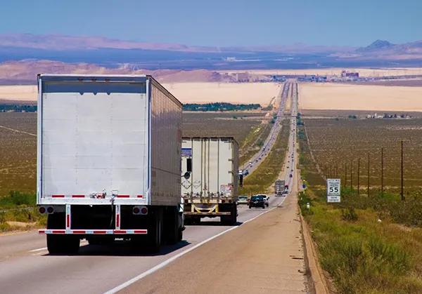 A long-distance moving truck on a highway.