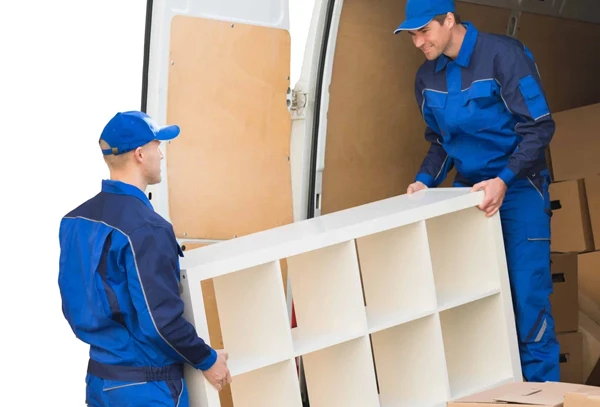 Movers loading a large item into a truck with precision and care.