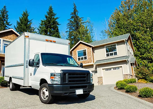 Moving truck in front of a house, symbolizing long-distance moving services.