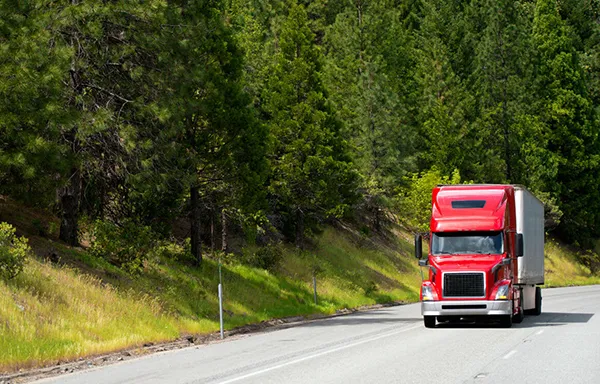 Long-distance moving truck on a highway, representing stress-free relocation services.
