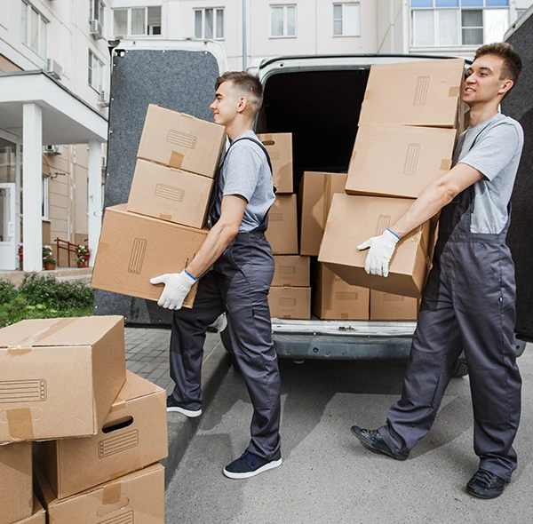 Two movers transporting boxes on a dolly during a residential move.